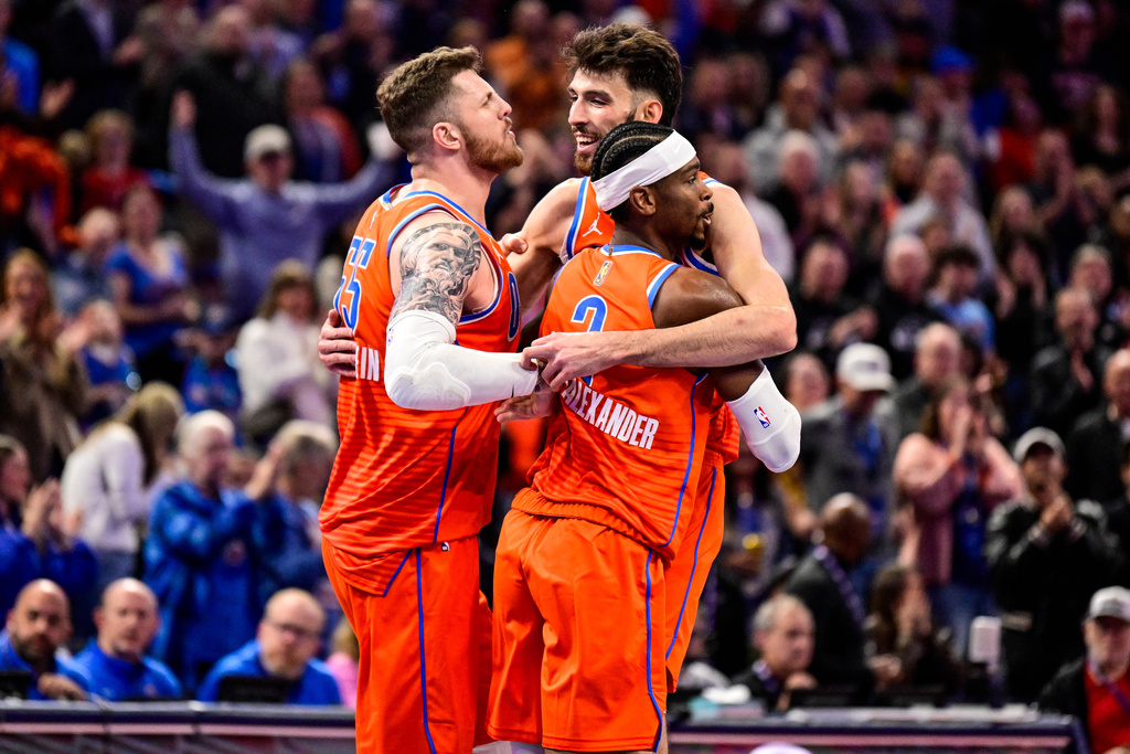 Oklahoma City Thunder center/forward Chet Holmgren (7), center, celebrates with Oklahoma City Thunder center/forward Isaiah Hartenstein (55) and Oklahoma City Thunder guard Shai Gilgeous-Alexander (2) during the second half of an Emirates NBA Cup basketball game, Wednesday, Nov. 26, 2025, in Oklahoma City. (AP Photo/Gerald Leong)