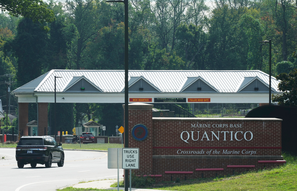 Vehicles drive to the entrance of Marine Corps Base Quantico, Friday Sep. 26, 2025, in Quantico, Va. (AP Photo/Steve Helber)