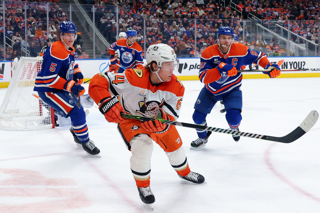 FILE - Anaheim Ducks' Mikael Granlund (64) looks on as Edmonton Oilers' Connor McDavid (97) and Connor Murphy (5) chase during the third period of an NHL game in Edmonton on March 28, 2026. (James Maclennan/The Canadian Press via AP, File)