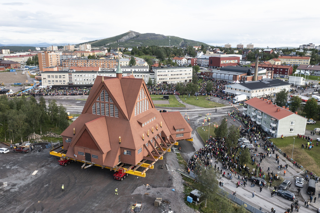 On a specially designed trolley with 224 wheels, Kiruna Church is moved for relocation at a speed of half a kilometer per hour, in Kiruna, Sweden, Tuesday Aug. 19, 2025. (Fredrik Sandberg/TT News Agency via AP)
