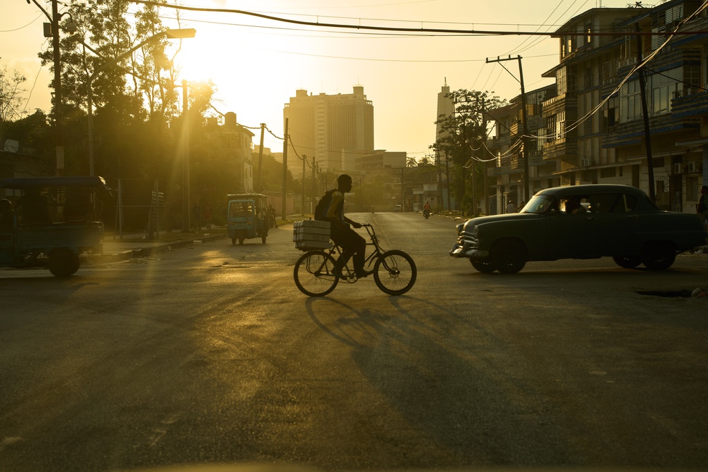 A man rides his bicycle at sunset in Havana, Wednesday, Feb. 18, 2026. (AP Photo/Ramon Espinosa)