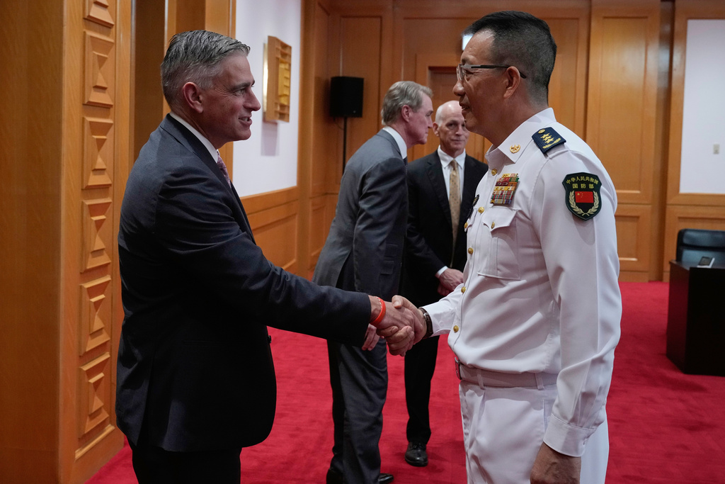Michael Baumgartner, Republican member of House Foreign Affairs Committee, left, shakes hands with Chinese Defense Minister Dong Jun at the Ministry of Defense in Beijing, China, Monday, Sept. 22, 2025. (AP Photo/Mahesh Kumar A., Pool)