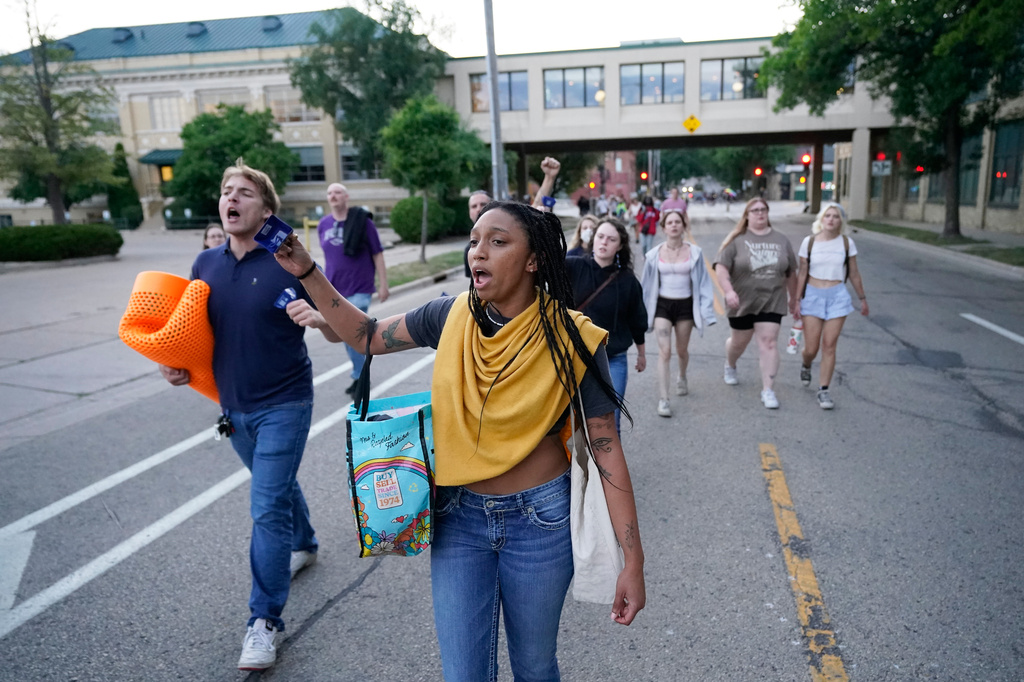 Protesters march after a Madison police officer shot and killed a man Wednesday, July 22, 2026, in Madison, Wis. (AP Photo/Kayla Wolf)