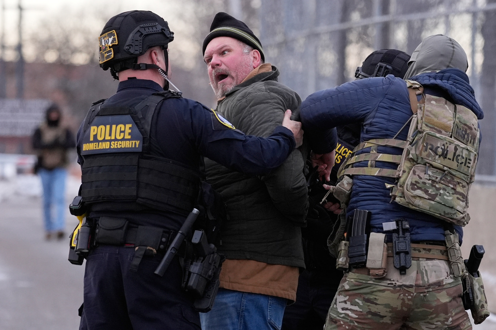 FILE - Law enforcement detain a man outside the Bishop Henry Whipple Federal Building during a protest, Jan. 17, 2026, in Minneapolis. (AP Photo/Yuki Iwamura, File)