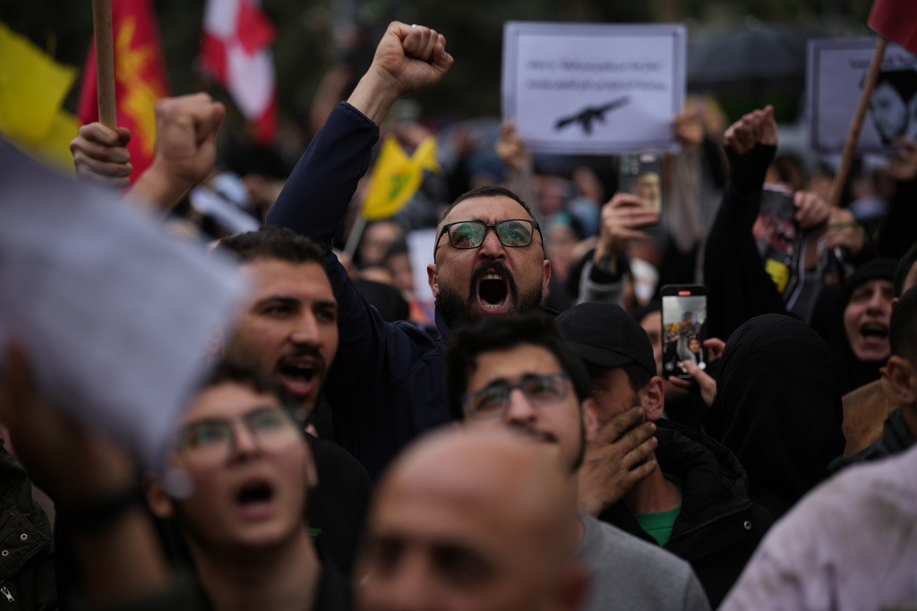 Hezbollah supporters shout slogans against the Lebanese Prime Minister Nawaf Salam during a protest in front the government palace, in Beirut, Lebanon, Friday, April 10, 2026. (AP Photo/Emilio Morenatti)