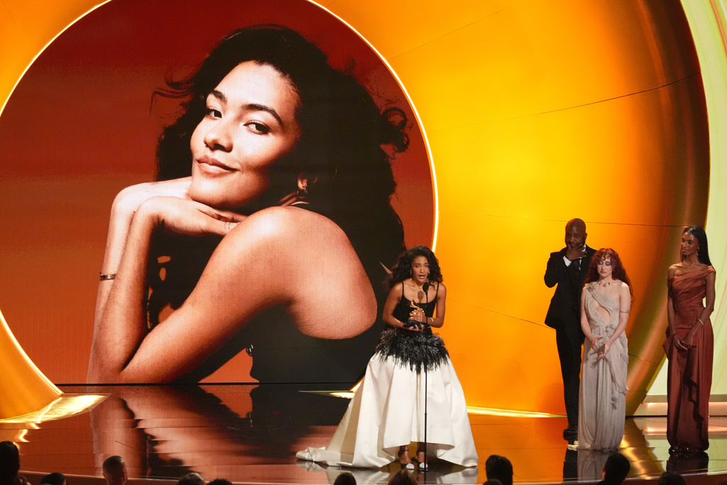 Olivia Dean accepts the award for best new artis during the 68th annual Grammy Awards on Sunday, Feb. 1, 2026, in Los Angeles. Chappell Roan looks on from right. (AP Photo/Chris Pizzello)