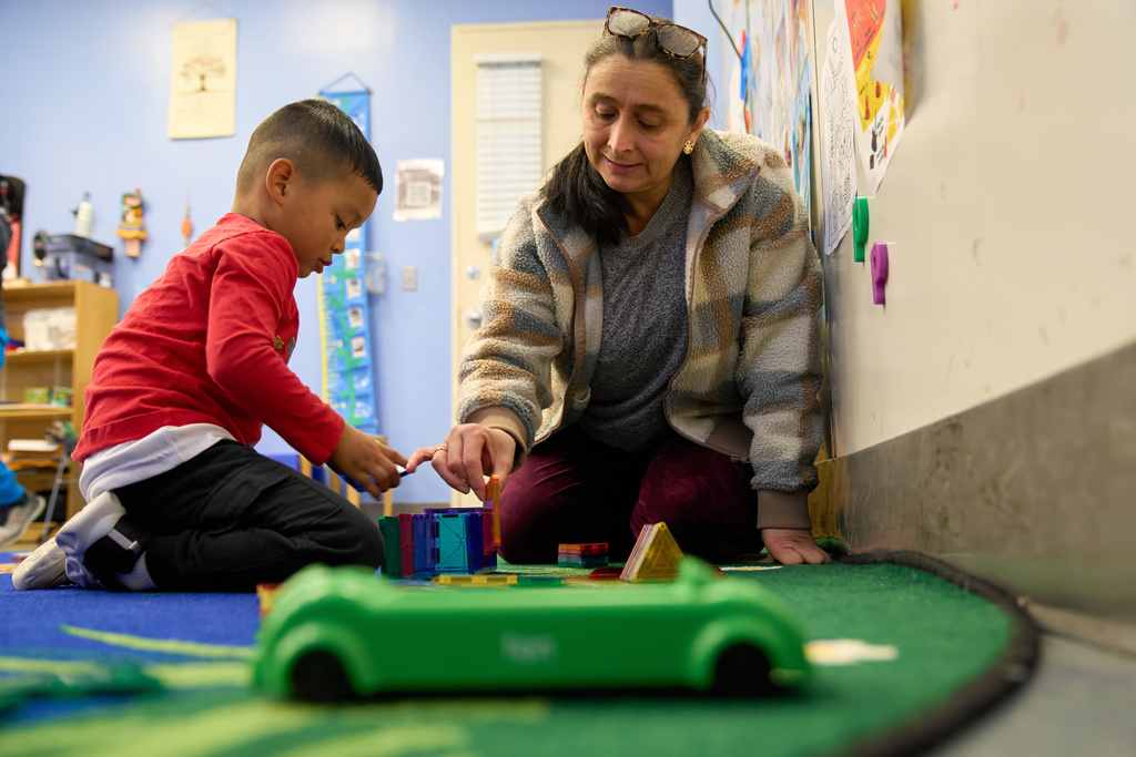 Belkis Mendez, builds with a Prek-5 student during playtime in their classroom at CentroNia in Washington, Tuesday, Dec. 9, 2025. (AP Photo/Jacquelyn Martin)