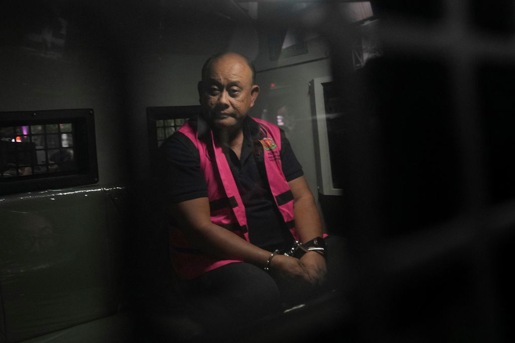 Former head of Indonesia's National Nutrition Agency Dadan Hindayana sits inside a detention car after being named as a corruption suspect, at the Attorney Genera's Office in Jakarta, Indonesia, Wednesday, June 3, 2026. (AP Photo/Achmad Ibrahim)