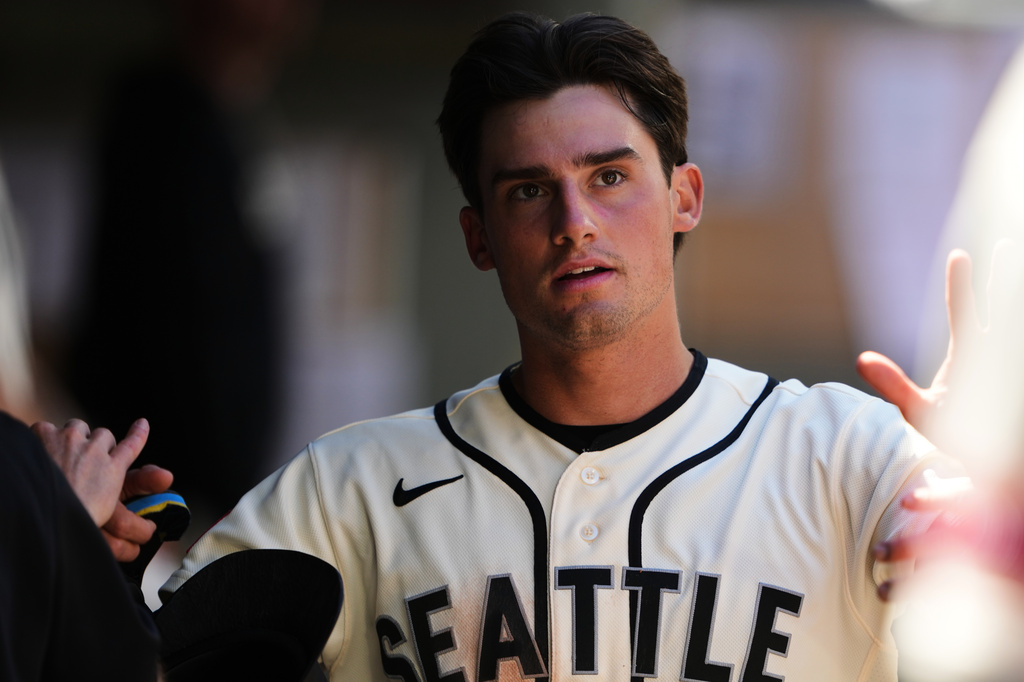 Seattle Mariners' Cole Young is greeted in the dugout after scoring after Cal Raleigh hit into a double play during the fifth inning of a baseball game against the San Francisco Giants, Sunday, July 19, 2026, in Seattle. (AP Photo/Lindsey Wasson)
