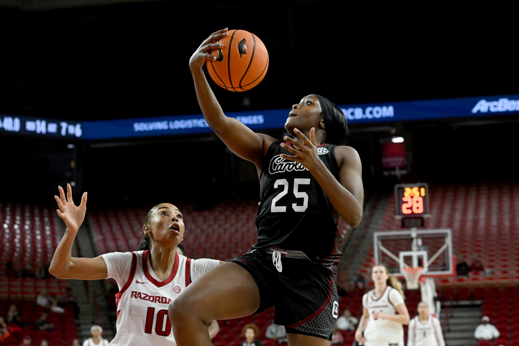 South Carolina guard Raven Johnson (25) drives past Arkansas guard Taleyah Jones (10) during the first half of an NCAA college basketball game Thursday, Jan. 8, 2026, in Fayetteville, Ark. (AP Photo/Michael Woods)