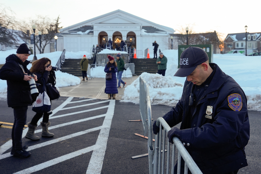 A New Castle police officer sets up barricades outside the Chappaqua Performing Arts Center as members of the media await the arrival of former Secretary of State Hillary Clinton who is testifying before U.S. House lawmakers as part of a congressional investigation into convicted sex offender Jeffrey Epstein, Thursday, Feb. 26, 2026, in Chappaqua, N.Y. (AP Photo/Yuki Iwamura)