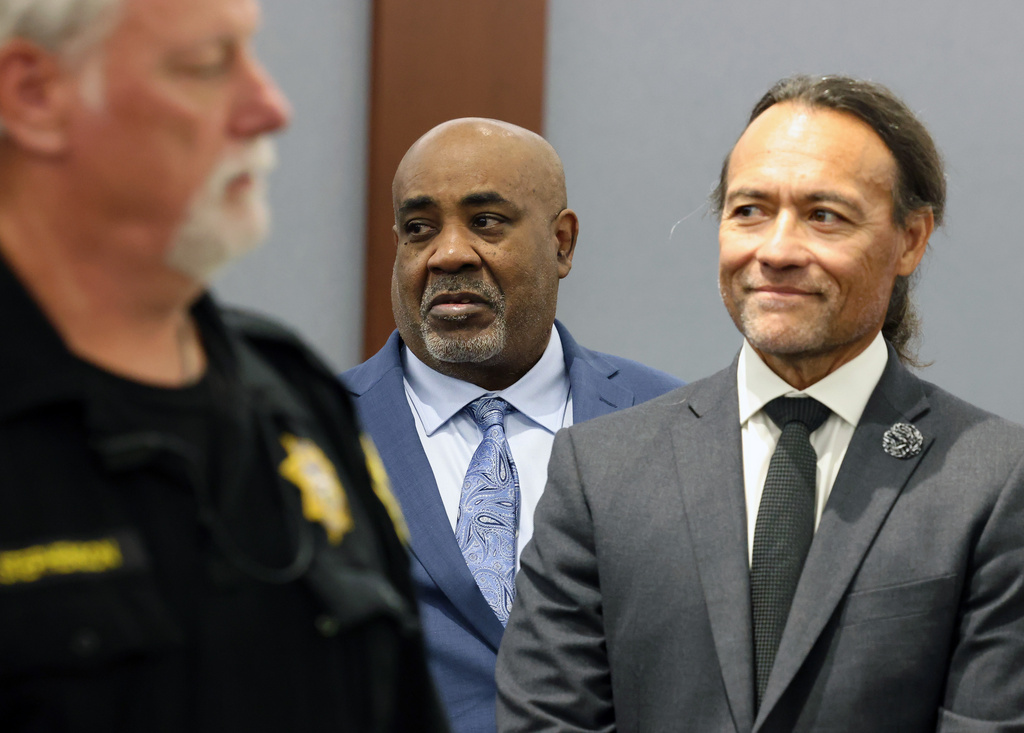 Duane Davis, center, stands with his attorney Michael Sanft, right, as prospective jurors enter the courtroom during the fourth day of jury selection for his murder trial in Clark County District Court at the Regional Justice Center on Thursday, Aug. 13, 2026, in Las Vegas. Davis was indicted on murder charges for his involvement in the killing of rapper Tupac Shakur in 1996. (Bizuayehu Tesfaye/Las Vegas Review-Journal via AP, Pool)