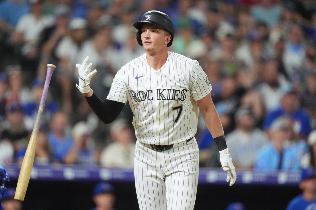 Colorado Rockies' TJ Rumfield flips his bat after connecting for a two-run home run off Chicago Cubs relief pitcher Jacob Webb in the eighth inning of a baseball game Wednesday, June 10, 2026, in Denver. (AP Photo/David Zalubowski)