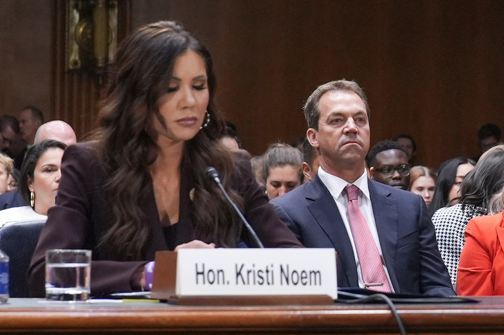 FILE - Homeland Security Secretary Kristi Noem, left, and her husband Bryon Noem, right, appears for an oversight hearing before the Senate Judiciary Committee, at the Capitol in Washington, March 3, 2026. (AP Photo/J. Scott Applewhite, File)