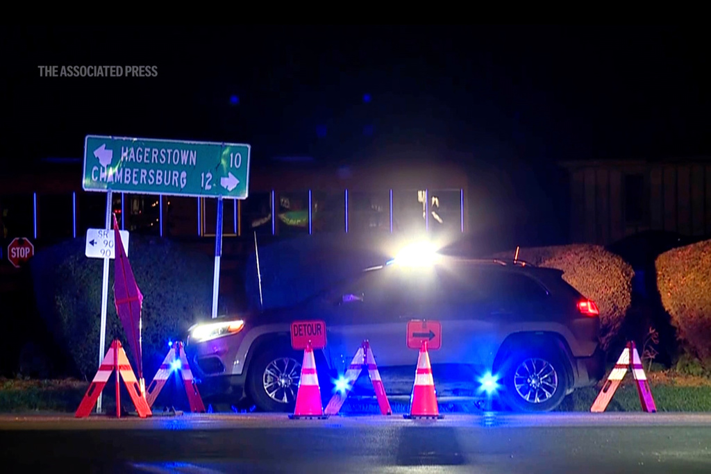 A police vehicle is seen at the site where two state police officers and a suspect were shot while officers were responding to a call, in southern Franklin County, about 85 miles (135 kilometers) northwest of Baltimore, Pa, Wednesday, Oct. 8, 2025. (WPMT/FOX43 via AP)
