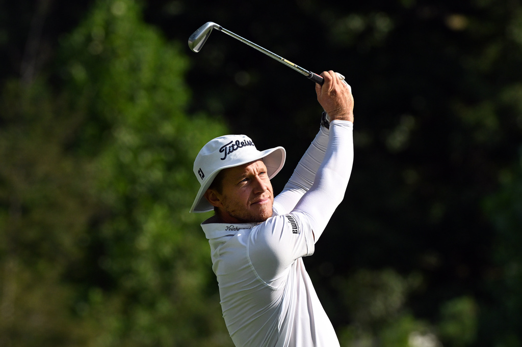 Peter Malnati hits from the 11th tee during the first round of the Rocket Classic golf tournament at the Detroit Golf Club, Thursday, July 30, 2026, in Detroit. (AP Photo/Jose Juarez)