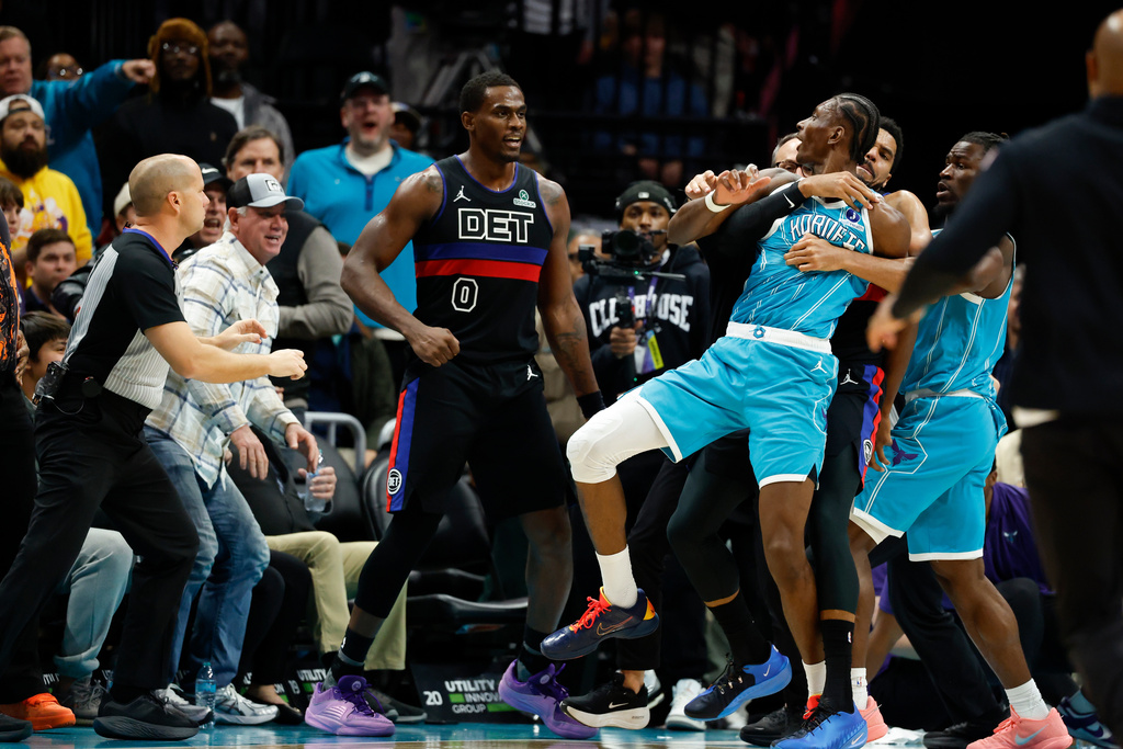 Charlotte Hornets forward Moussa Diabate is held back as he fights with Detroit Pistons center Jalen Duren (0) during the second half of an NBA basketball game in Charlotte, N.C., Monday, Feb. 9, 2026. (AP Photo/Nell Redmond)