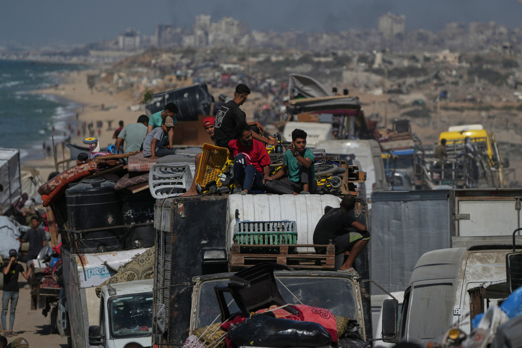 Displaced Palestinians flee northern Gaza Strip, by foot and in vehicles, carrying their belongings along the coastal road, near Wadi Gaza, Tuesday, Sept. 23, 2025. (AP Photo/Abdel Kareem Hana)