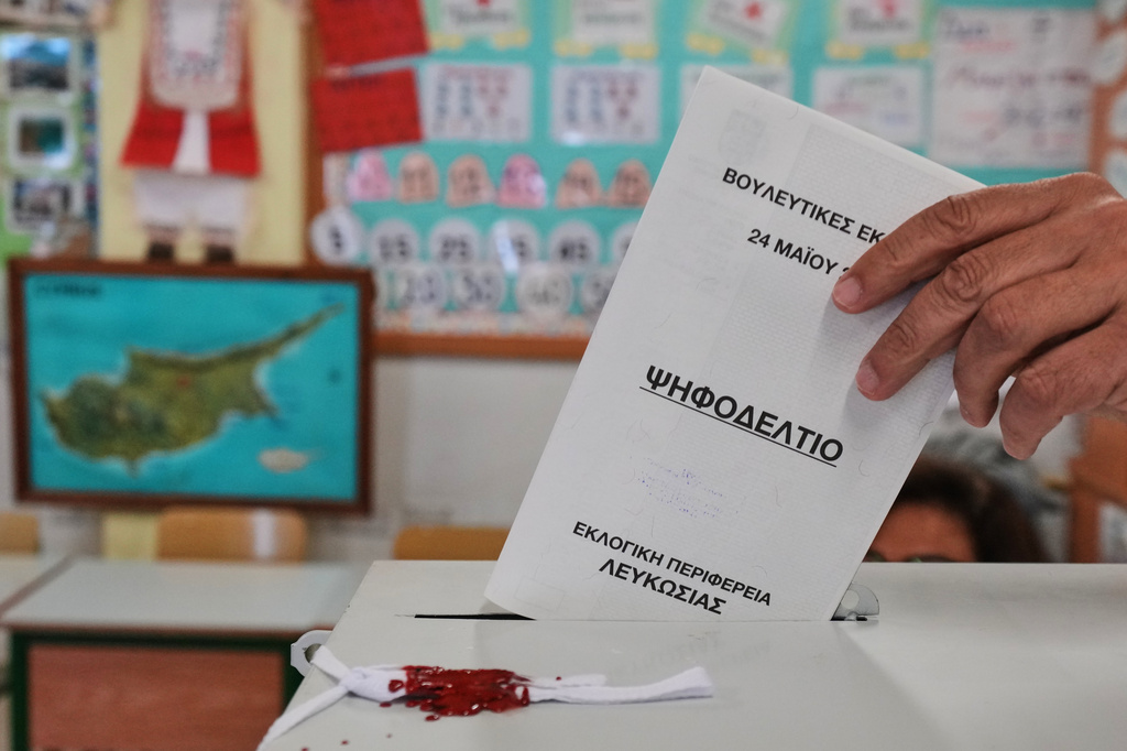 A voter casts a ballot at a polling station during the parliamentary elections in capital Nicosia, Cyprus, Sunday, May 24, 2026. (AP Photo/Petros Karadjias)