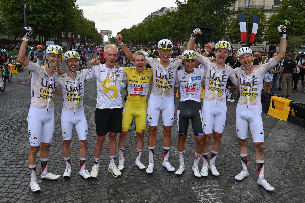 Slovenia's Tadej Pogacar, wearing the overall leader's yellow jersey, celebrates with his UAE Team Emirates XRG teammates after the the last stage of the Tour de France cycling race in Paris, Sunday, July 26, 2026. (AP Photo/Dario Belingheri/Pool Photo via AP)