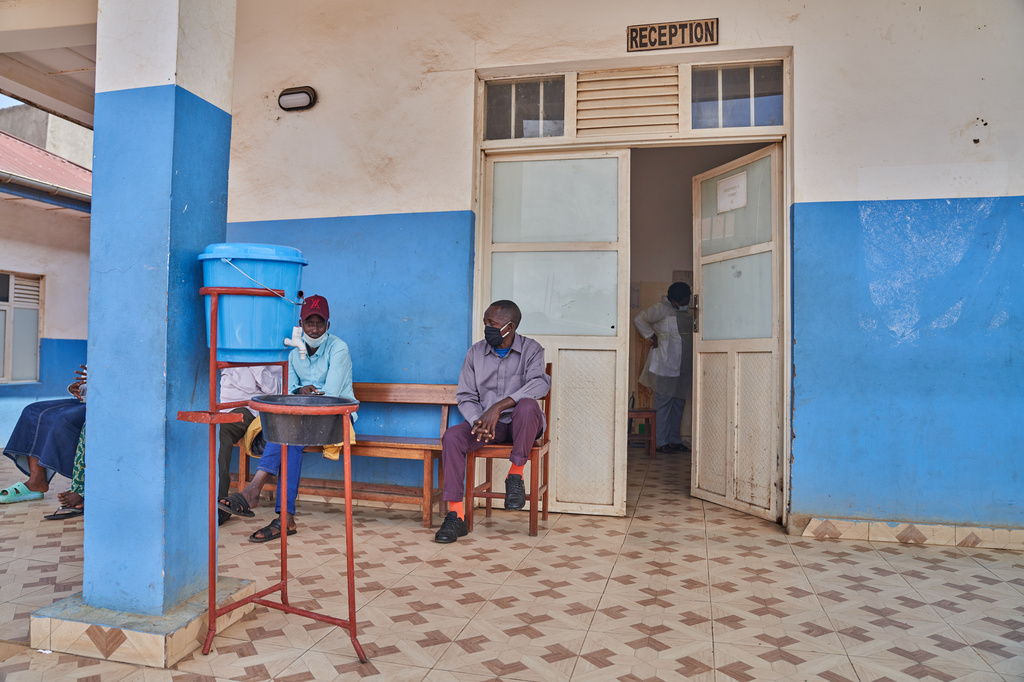 People wait outside a hospital reception in Bunia, Congo, Tuesday, May 19, 2026. (AP Photo/Dirole Lotsima Dieudonne)