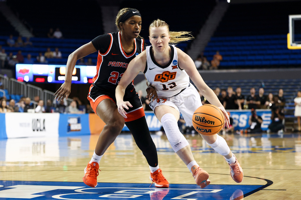 Oklahoma State guard Haleigh Timmer (13) dribbles against Princeton guard Madison St. Rose, left, during the first half in the first round of the NCAA college basketball tournament, Saturday, March 21, 2026, in Los Angeles. (AP Photo/Jessie Alcheh)