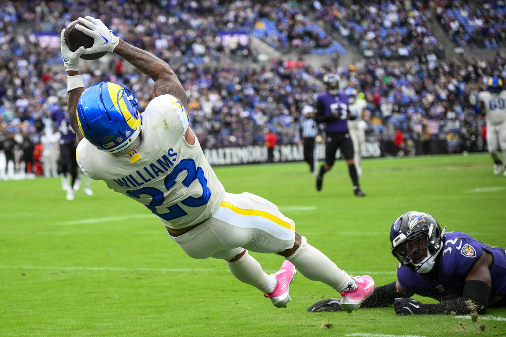 Los Angeles Rams running back Kyren Williams (23) makes a catch after beating the defense of Baltimore Ravens linebacker Trenton Simpson (32) during the second half of an NFL football game Sunday, Oct. 12, 2025, in Baltimore. (AP Photo/Nick Wass)