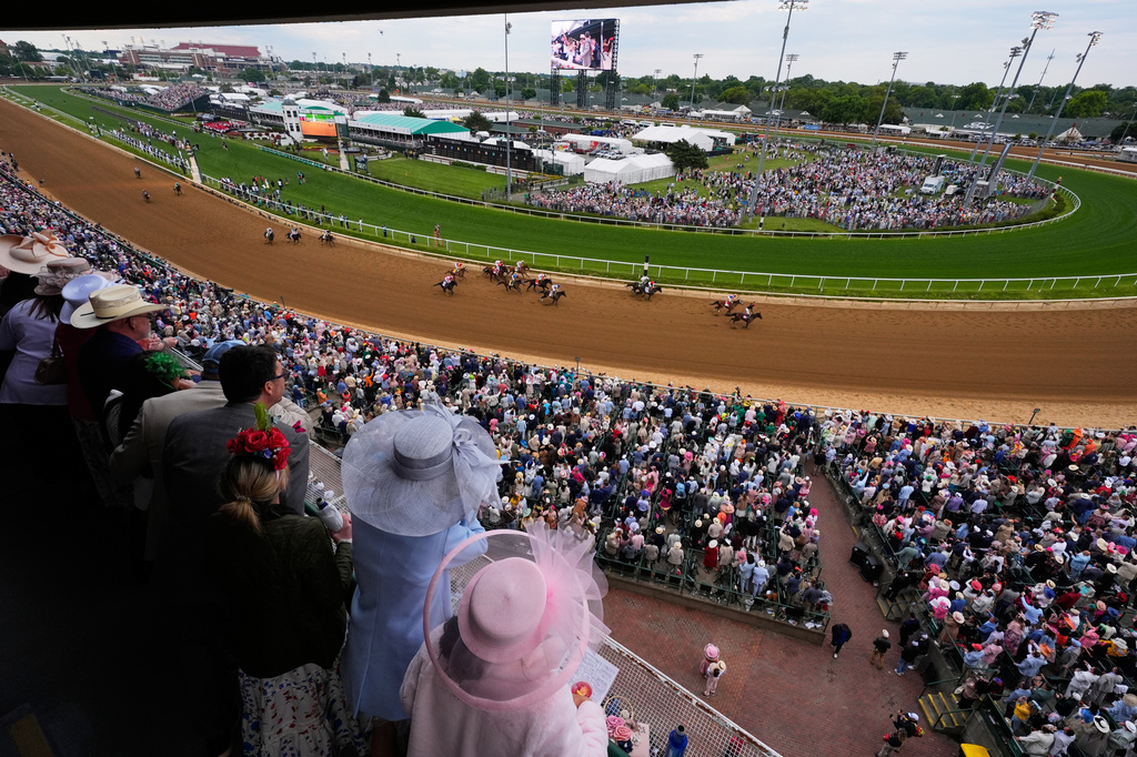 FILE - Fans watch as Golden Tempo (19) ridden by Jose L. Ortiz wins the 152nd running of the Kentucky Derby horse race at Churchill Downs, May 2, 2026, in Louisville, Ky. (AP Photo/Charlie Riedel, File)