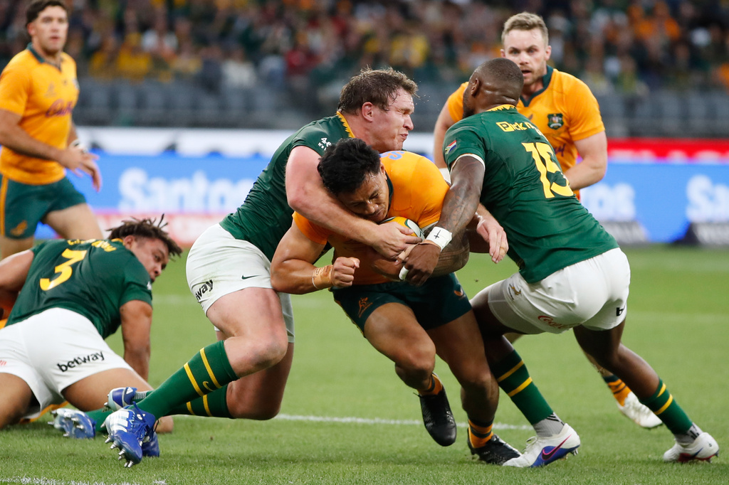 Australia's Len Ikitau, center, charges though South Africa's Aphelele Fassi, right, to score a try during their rugby union test match in Perth, Australia, on Sunday, Sept. 27, 2026. (AP Photo/Gary Day)