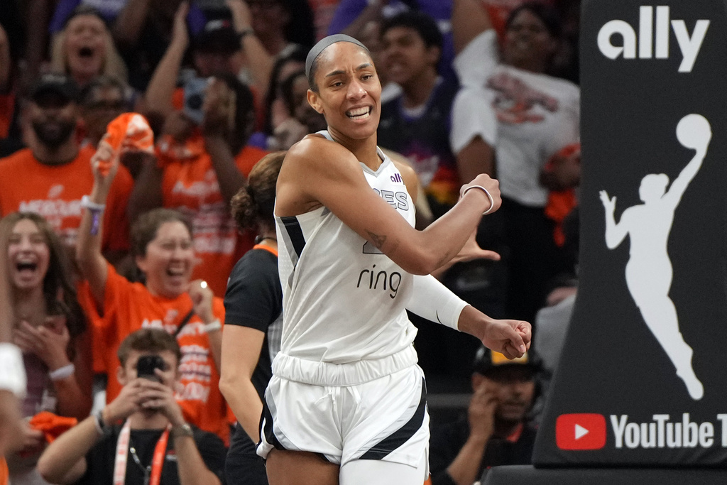Las Vegas Aces center A'ja Wilson reacts after a play against the Phoenix Mercury during the second half of Game 3 of the WNBA basketball finals, Wednesday, Oct. 8, 2025, in Phoenix. (AP Photo/Rick Scuteri)
