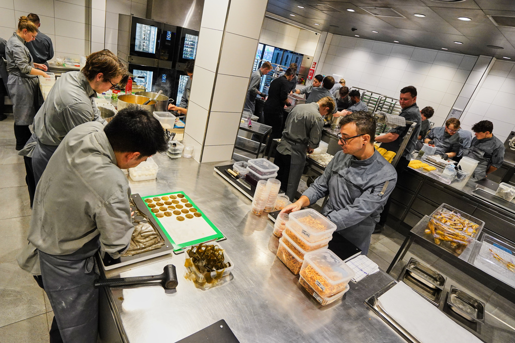 Chefs prepare the dishes inside the prep kitchen at restaurant Alchemist in Copenhagen, Denmark, Feb. 11, 2026. (AP Photo/James Brooks)