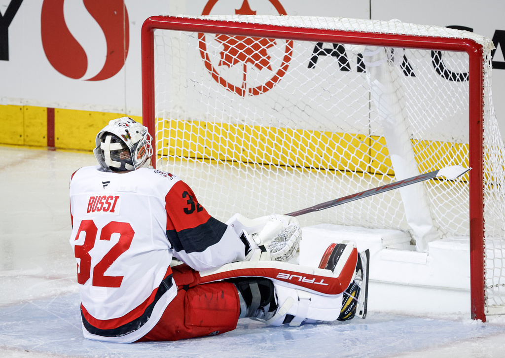 Carolina Hurricanes goalie Brandon Bussi reacts after letting in a goal during second period NHL hockey action against the Calgary Flames in Calgary on Saturday, March 7, 2026. (Jeff McIntosh/The Canadian Press via AP)