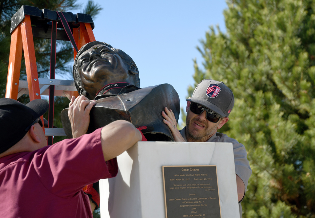 City worker Zak Merten removes a bust of César Chavez at César E. Chavez Park in Denver on Thursday, March 19, 2026. (AP Photo/Thomas Peipert)
