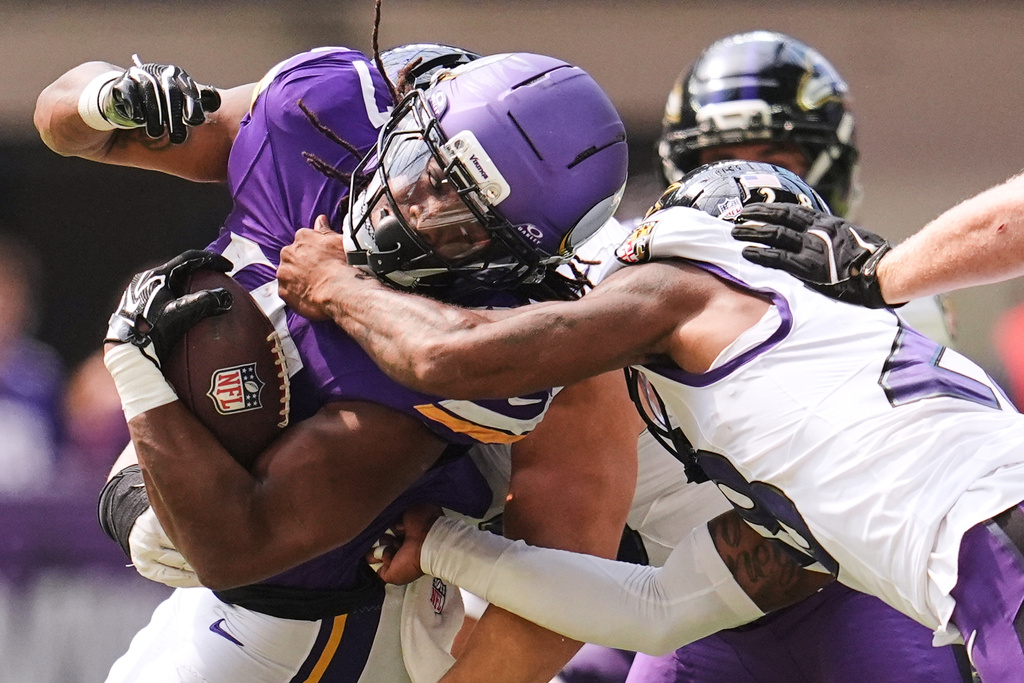 Minnesota Vikings running back Jermar Jefferson, left, is tackled by Baltimore Ravens cornerback Marquise Robinson, right, during the second half of an NFL preseason football game, Saturday, Aug. 22, 2026, in Minneapolis. (AP Photo/Abbie Parr)