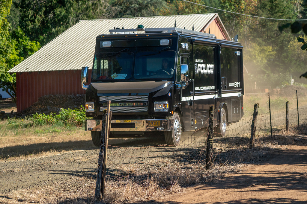 A Hillsboro Police mobile command center travels near the home where police are investigating a mass killing in unincorporated Washington County near Forest Grove, Ore., Sunday, Aug. 23, 2026. (Mark Graves/The Oregonian via AP)