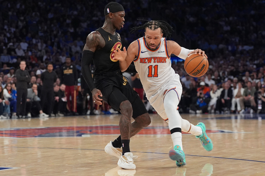 New York Knicks' Jalen Brunson, right, moves past Cleveland Cavaliers' Dennis Schroder, left, during the second half of Game 1 in the Eastern Conference finals NBA basketball playoffs series, Tuesday, May 19, 2026, in New York. (AP Photo/Seth Wenig)