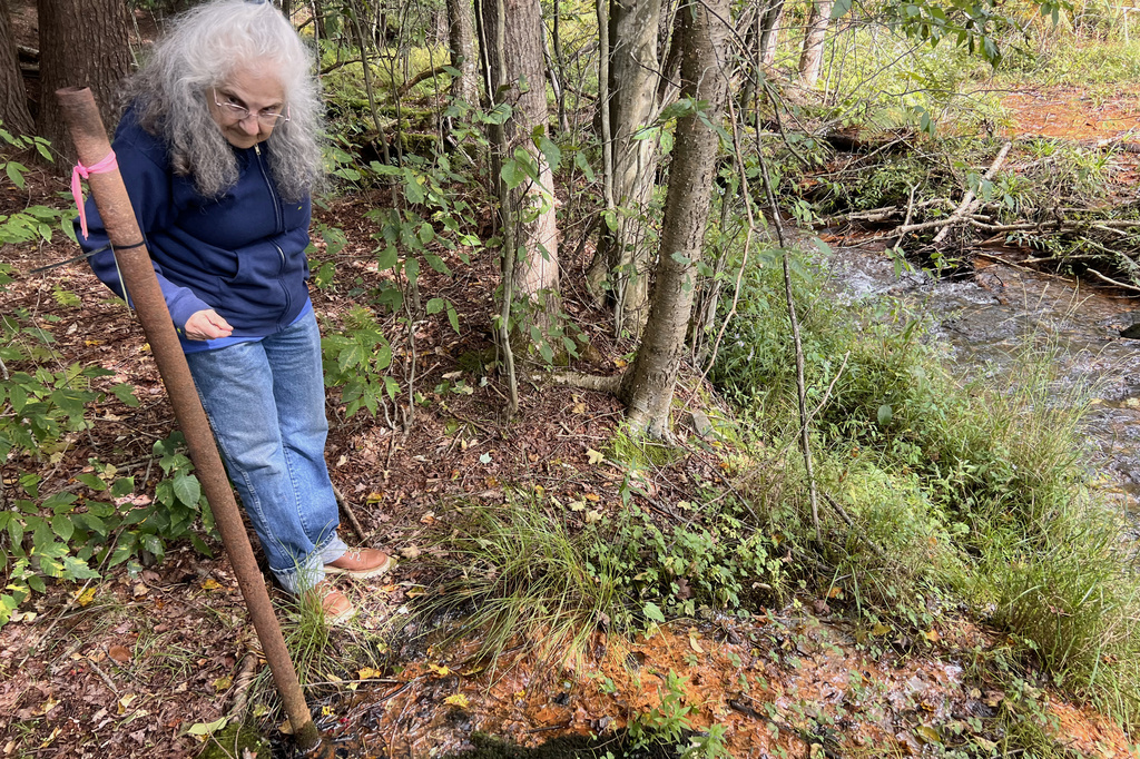 Barbara Laxon stands next to an abandoned, uncapped oil well near Bradford, Pa., on Sept. 15, 2026. (Kate Huangpu/Spotlight PA via AP)