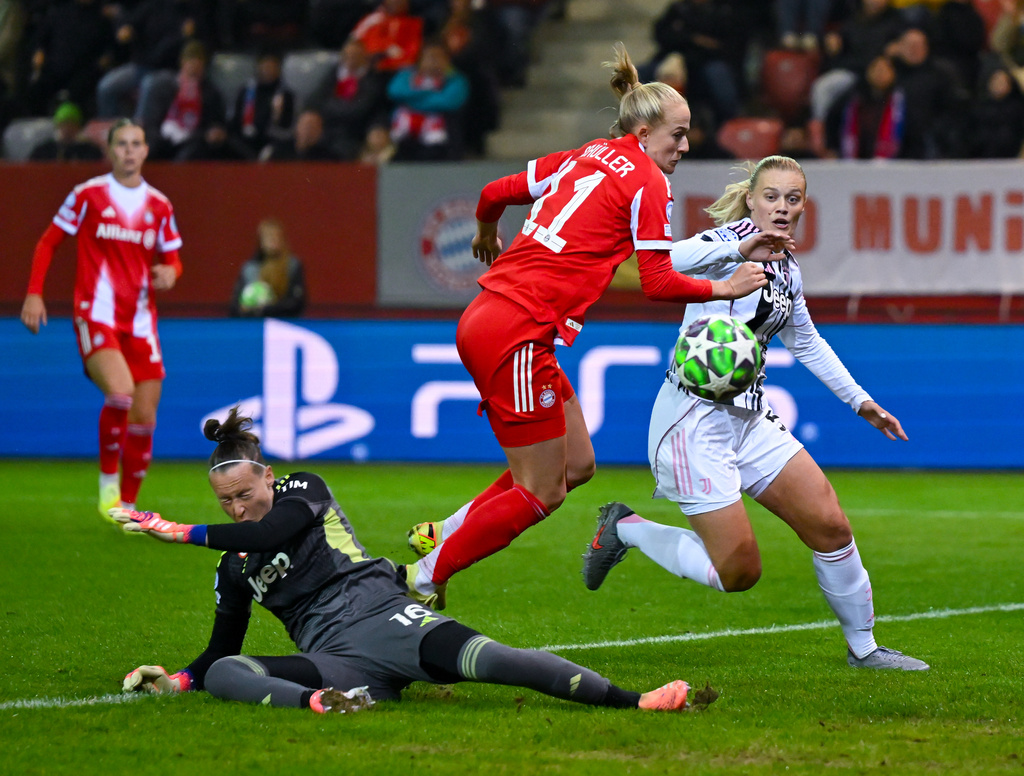 Bayern Munich's Lea Schüller, center, looks on as Juventus' Mathilde Harviken, right, and goalkeeper Pauline Peyraud-Magnin are unable to prevent Schüller's goal during a Champions League women's soccer match, Thursday, Oct. 16, 2025 in Munich, Germany. (Sven Hoppe/dpa via AP)
