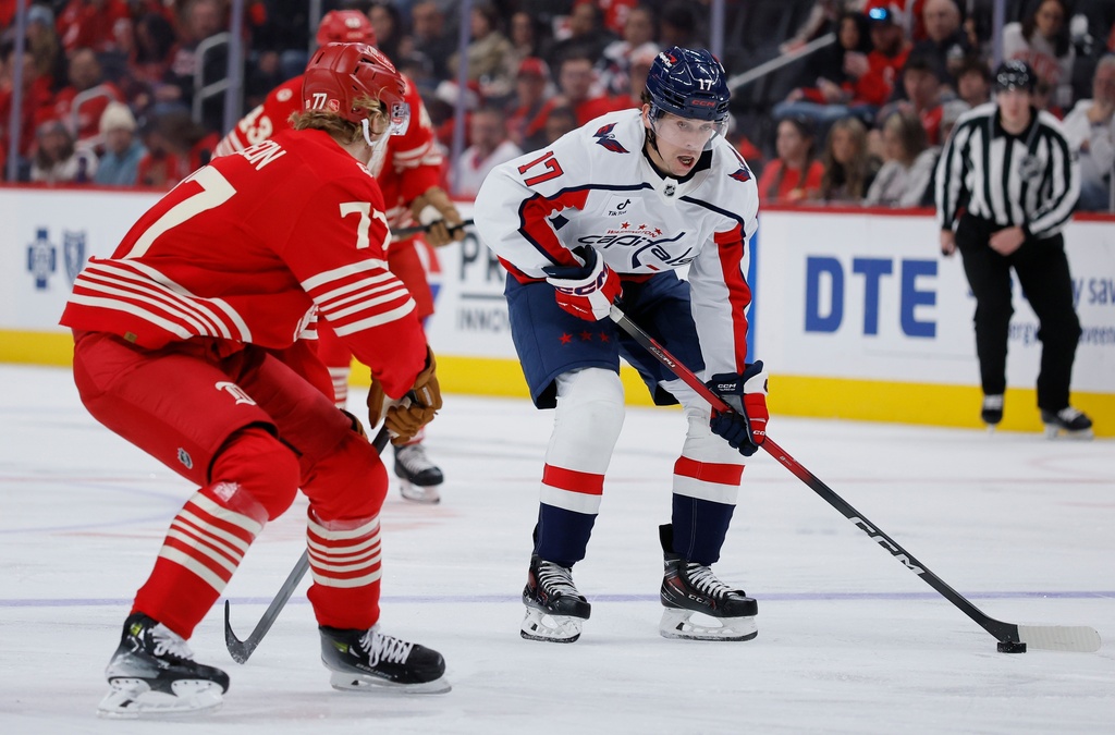 Washington Capitals center Dylan Strome (17) drives towards the goal against Detroit Red Wings defenseman Simon Edvinsson (77) during the second period of an NHL hockey game Sunday, Dec. 21, 2025, in Detroit. (AP Photo/Duane Burleson)
