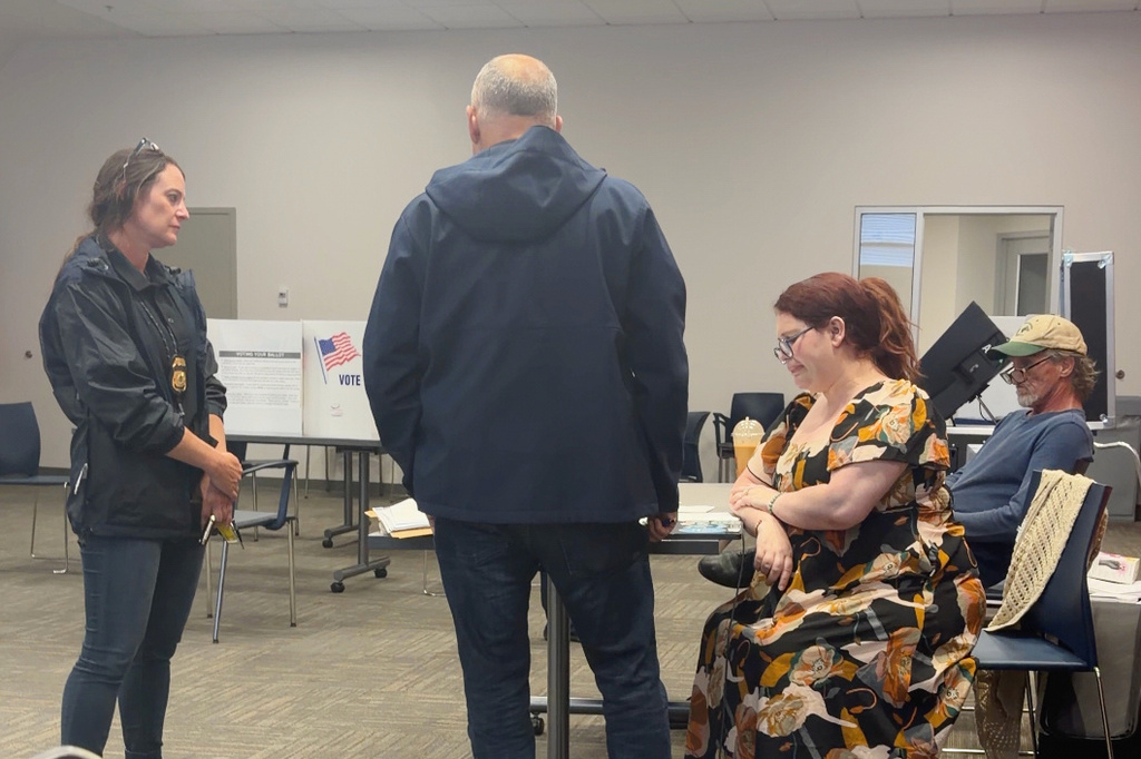 In this image from video provided by Sheilia Milledge, Paigelynne Gonyea, right, is presented with a form at a polling place on Tuesday, June 23, 2026, in Syracuse, N.Y. (Sheilia Milledge via AP)