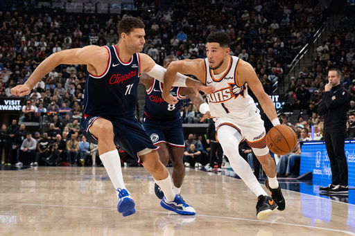 Phoenix Suns guard Devin Booker (1) drives to the basket as Los Angeles Clippers center Brook Lopez (11) defends during the first half of an NBA basketball game Friday, Oct. 24, 2025, in Inglewood, Calif. (AP Photo/Kyusung Gong) Phoenix Suns guard Devin Booker (1) drives to the basket as Los Angeles Clippers center Brook Lopez (11) defends during the first half of an NBA basketball game Friday, Oct. 24, 2025, in Inglewood, Calif. (AP Photo/Kyusung Gong)