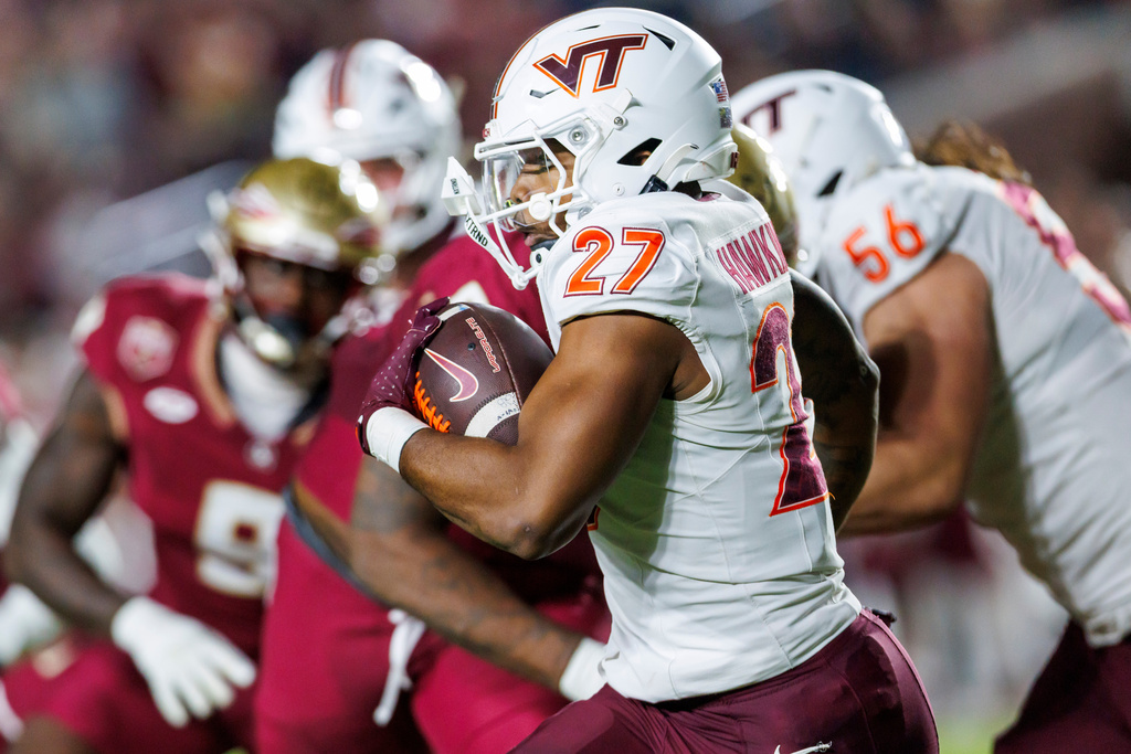 Virginia Tech running back Marcellous Hawkins (27) rushes against Florida State during the first half of an NCAA college football game, Saturday, Nov. 15, 2025, in Tallahassee, Fla. (AP Photo/Colin Hackley)