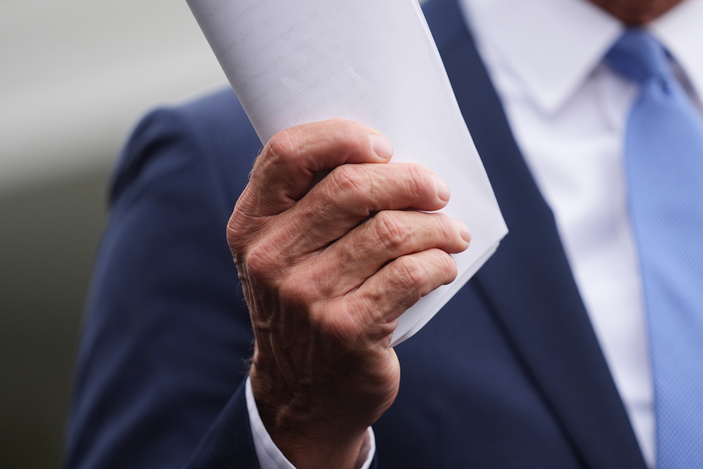 Senate Majority Leader John Thune, R-S.D., holds documents as he speaks to members of the media outside the West Wing at the White House in Washington, Monday, Sept. 29, 2025, in Washington. (AP Photo/Evan Vucci)