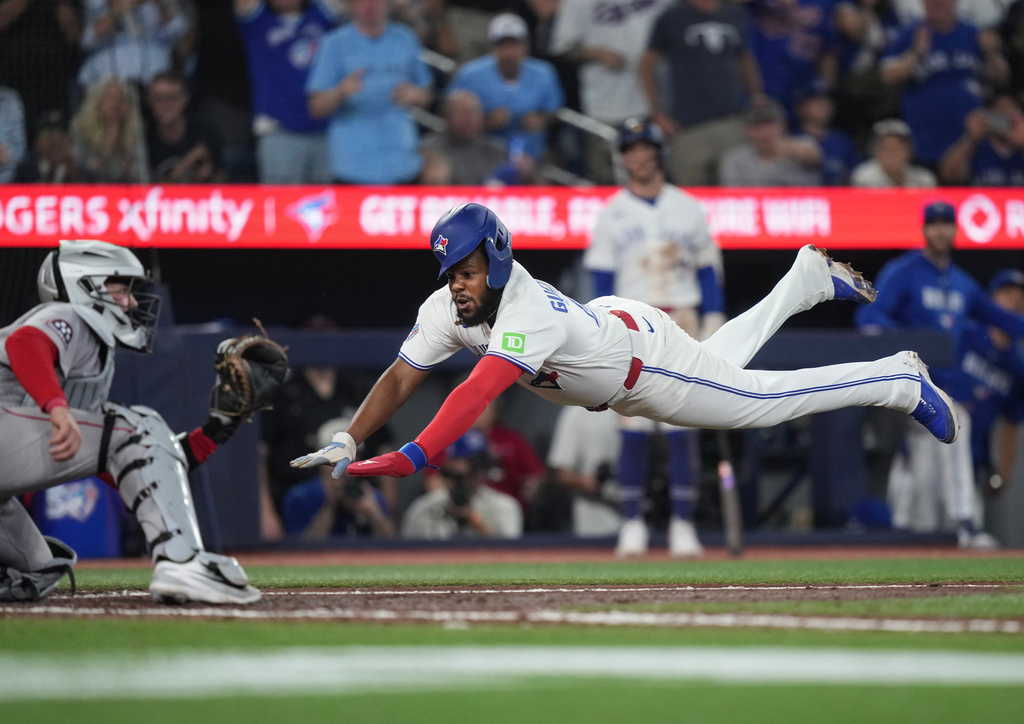 Toronto Blue Jays first baseman Vladimir Guerrero Jr. (27) reacts to the Boston Red Sox dugout after hitting into a double play during fifth inning American League MLB baseball action in Toronto on Wednesday, August 12, 2026. (Nathan Denette/The Canadian Press via AP)