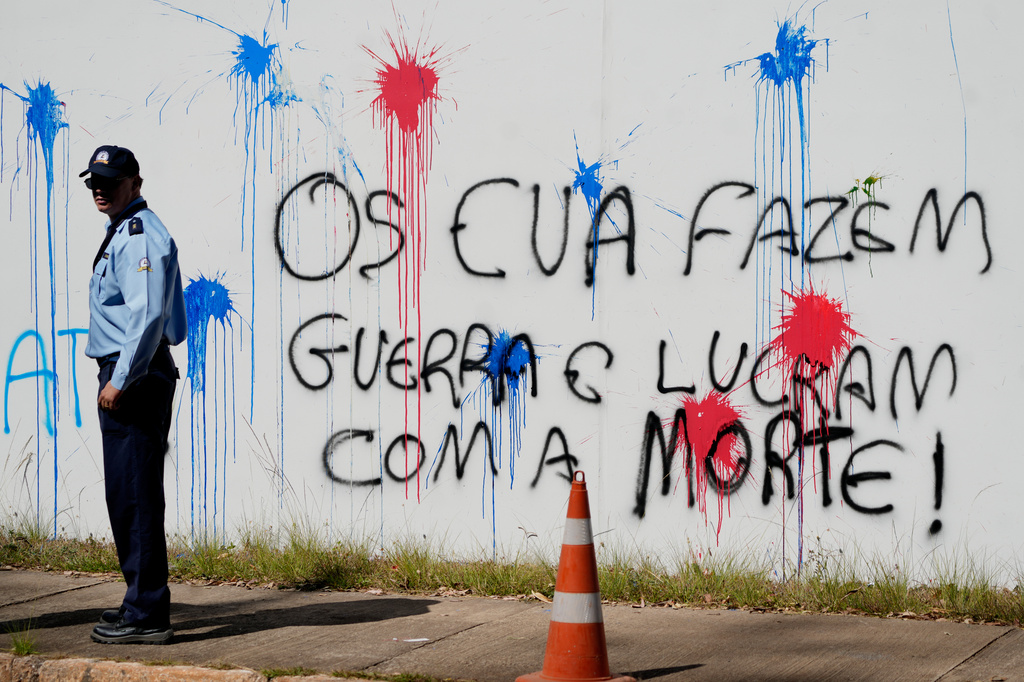 Graffiti that reads in Portuguese: "The U.S. makes war and profits from death," covers a wall at the U.S. Embassy in Brasília, Brazil, Thursday, Aug. 13, 2026. (AP Photo/Eraldo Peres)