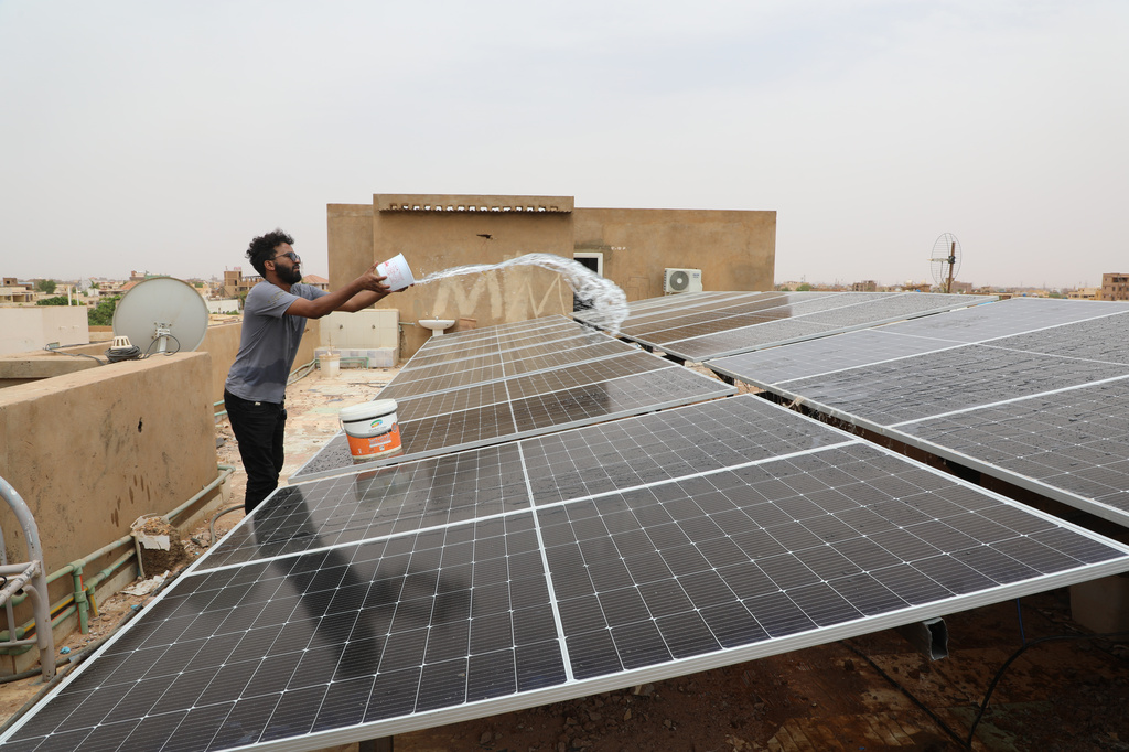 A technician cleans solar panels installed on the roof of a home in Omdurman, on the outskirts of Khartoum, Sudan, July 23, 2026. (AP Photo/Mohnd Blal)