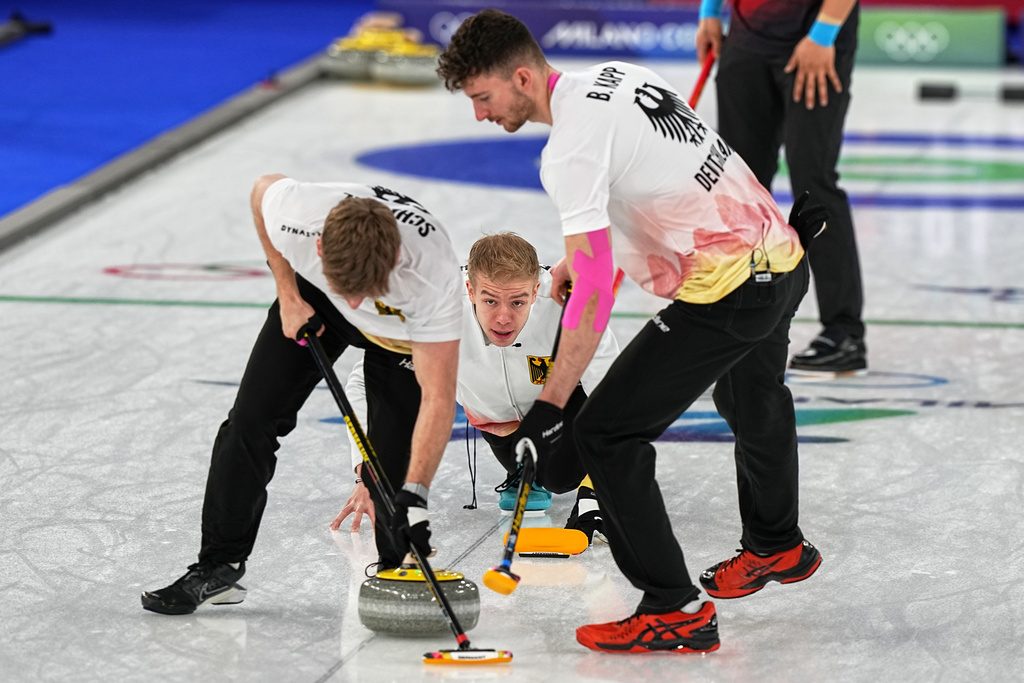 Germany's Benjamin Kapp, Felix Messenzehl and Johannes Scheuerl in action during the men's curling round robin session against China at the 2026 Winter Olympics, in Cortina d'Ampezzo, Italy, Thursday, Feb. 19, 2026. (AP Photo/Fatima Shbair)