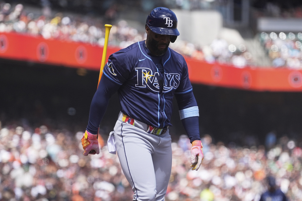 Tampa Bay Rays' Yandy Díaz walks to the dugout after striking out against the San Francisco Giants during the sixth inning of a baseball game in San Francisco, Sunday, Aug. 17, 2025. (AP Photo/Jeff Chiu)
