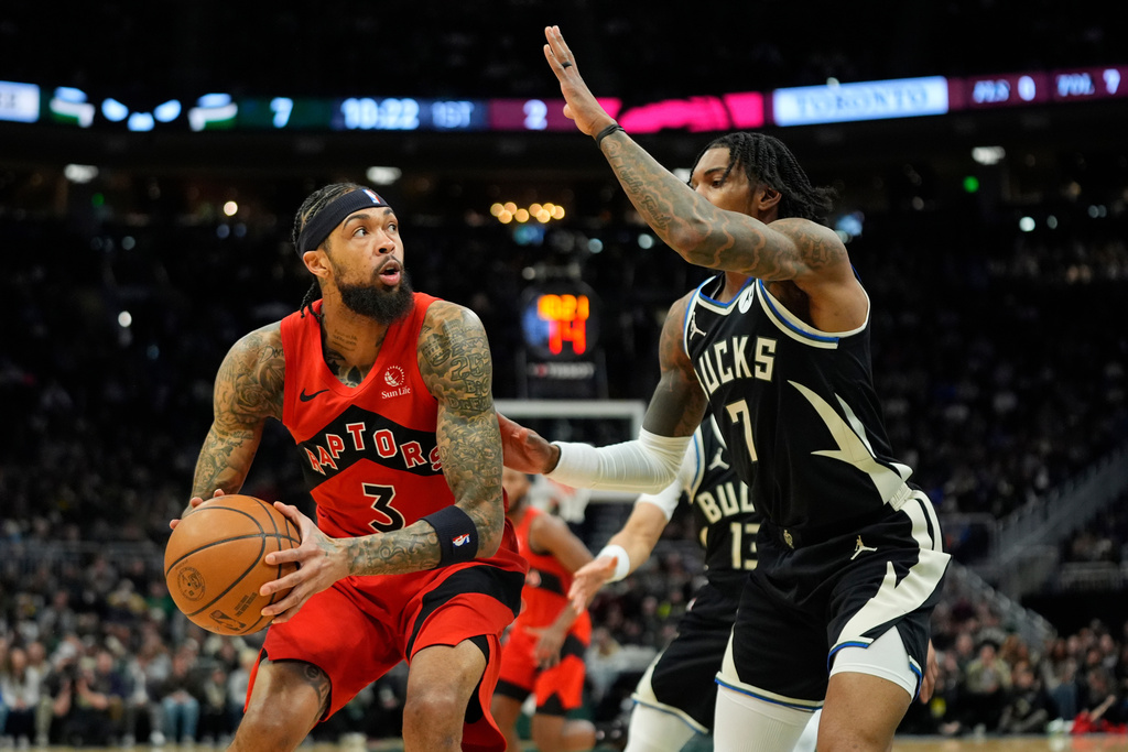 Toronto Raptors' Brandon Ingram looks to shoot against Milwaukee Bucks' Kevin Porter Jr. during the first half of an NBA basketball game Sunday, Feb. 22, 2026, in Milwaukee. (AP Photo/Aaron Gash)