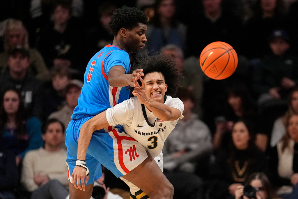Vanderbilt guard Tyler Tanner (3) passes the ball past Mississippi forward Malik Dia (0) during the first half of an NCAA college basketball game Saturday, Jan. 31, 2026, in Nashville, Tenn. (AP Photo/George Walker IV)